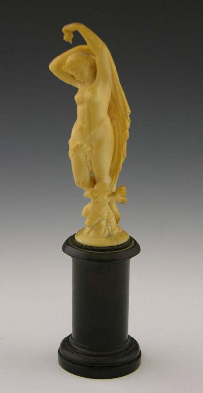 French Carved Ivory Nude Figure, 19th c., of a cla: French Carved Ivory Nude Figure, 19th c., of a classical female with a cherub at her feet, on an ebonized turned wood column, Figure- H.- 5 in., Dia.- 2 in., Total H.- 8 1/8 in.