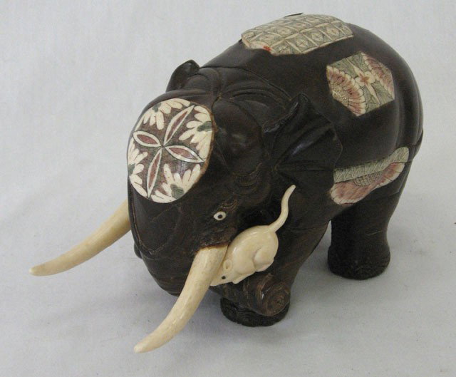Oriental Carved Rosewood Elephant, early 20th c., : Oriental Carved Rosewood Elephant, early 20th c., with bone tusks, the body inlaid with polychromed scrimshaw bone panels, the elephant holding a log in its trunk mounted with an ivory rat, signed on 