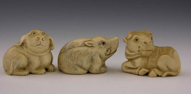 Three Carved Ivory Animal Netsukes, 20th c., of a : Three Carved Ivory Animal Netsukes, 20th c., of a boar, a dog and a horse, each signed on the underside.