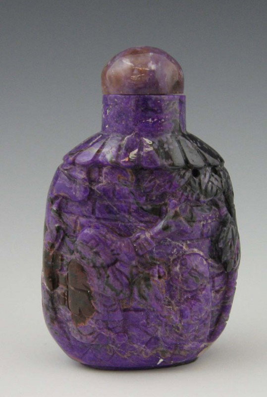 Carved Sugilite Snuff Bottle, early 20th c., with: Carved Sugilite Snuff Bottle, early 20th c., with relief figural decoration, H.- 2 in., W.- 1 1/4 in., D.- 3/4 in. Provenance: Collection of Virginia A. Rice, New Orleans Louisiana; member of the Inte
