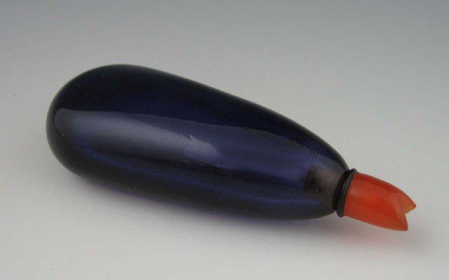 Purple Glass Eggplant Form Snuff Bottle, early 20t: Purple Glass Eggplant Form Snuff Bottle, early 20th c., the stopper of stem form Carved carnelian, H.- 3 in., W.- 1 1/4 in., D.- 7/8 in. Provenance: Collection of Virginia A. Rice, New Orleans Louisia