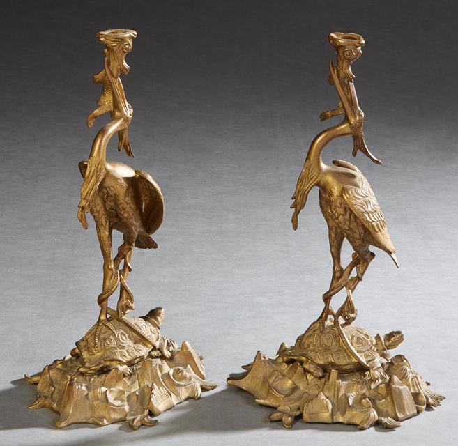 Pair of Oriental Brass Crane Candlesticks, early 20th c., the crane standing on a turtle, upholding (1 of 2)