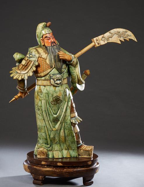 Large Japanese Polychromed Bone Clad Wood Samurai, 20th c., with a sword on his back and an axe in: Large Japanese Polychromed Bone Clad Wood Samurai, 20th c., with a sword on his back and an axe in one hand, on an integral polychromed oval wood base, Figure- H.- 39 1/2 in., W.- 21 in., D.- 14 in. P