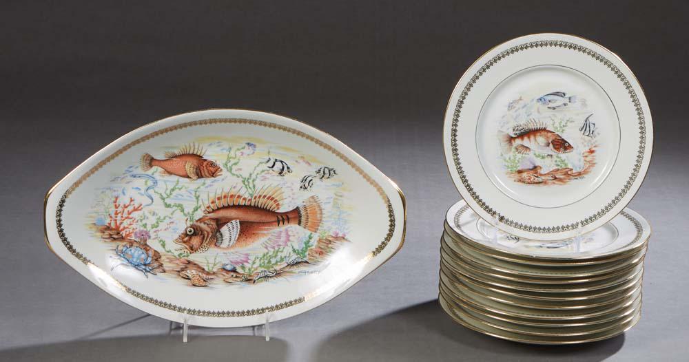Thirteen Piece French Porcelain Fish Set, 20th c., by P.L., consisting of twelve circular plates and (1 of 2)