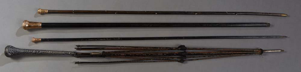 Group of Three Canes, late 19th c., and an umbrella frame, the three ebonized canes with gold filled (1 of 2)