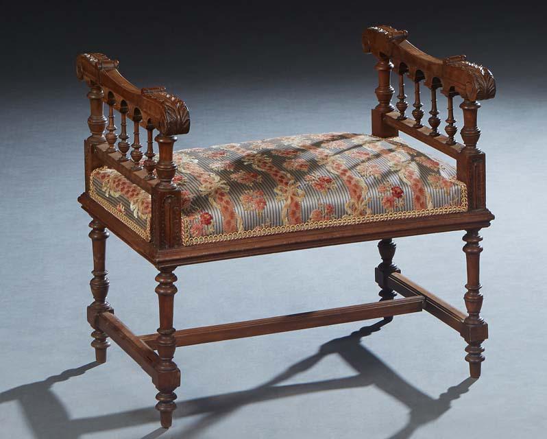 French Henri II Style Carved Walnut Piano Bench, late 19th c., the leaf carved arms over spindled (1 of 1)