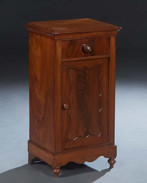 American Carved Mahogany Nightstand, late 19th c., the stepped top over a frieze drawer and a lower: American Carved Mahogany Nightstand, late 19th c., the stepped top over a frieze drawer and a lower cupboard door, on a scalloped plinth base on turned legs, H.- 30 3/4 in., W.- 16 in., D.- 13 in.
