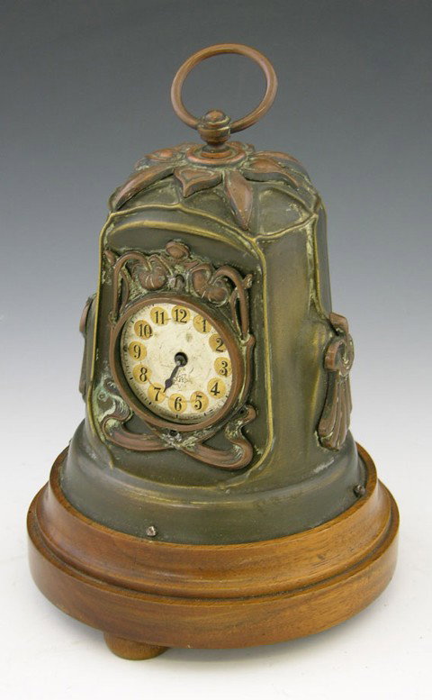 Unusual Brass and Copper Art Nouveau German Desk Al: Unusual Brass and Copper Art Nouveau German Desk Alarm Clock, c. 1900, by Junghans, of tapered pylon shape, with relief decoration, on a stepped circular mahogany base, H.- 8 in., Dia.- 5 3/8 in.