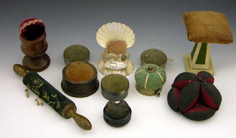 Group of Ten Pin Cushions, early 20th c.- a tape m: Group of Ten Pin Cushions, early 20th c.- a tape measure, rolling pin, "Merry Xmas," ebony box, etc. (10 Pcs.)