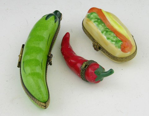 Group of Three Limoges Hand Painted Dresser Boxes,: Group of Three Limoges Hand Painted Dresser Boxes, 20th c., in the form of a hot dog, a green pea pod, and a red chili pepper.