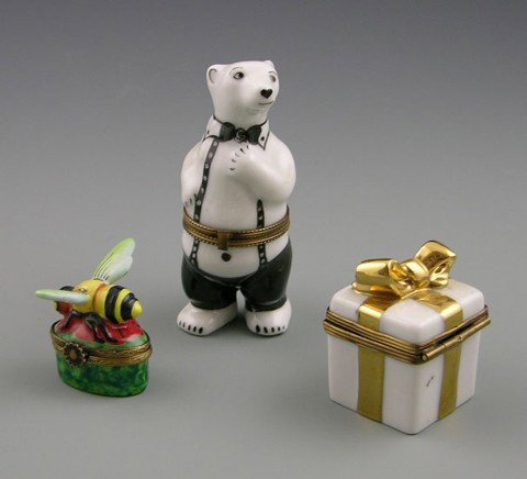 Group of Three Limoges Hand Painted Dresser Boxes,: Group of Three Limoges Hand Painted Dresser Boxes, 20th c., in the form of a wrapped present, a bee, and a well dressed bear.