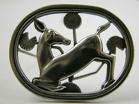 George Jensen Sterling Art Deco Brooch, # 256, of: George Jensen Sterling Art Deco Brooch, # 256, of a kneeling deer amidst flowers, designed in 1937 by Arno Malinowski, H.- 1 3/8 in., W.- 1 3/4 in.