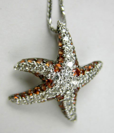 14K White Gold Starfish Pendant, each of the five: 14K White Gold Starfish Pendant, each of the five arms studded with small round diamonds over orange sapphires, on a tiny link white gold mesh chain, L.- 17 in.