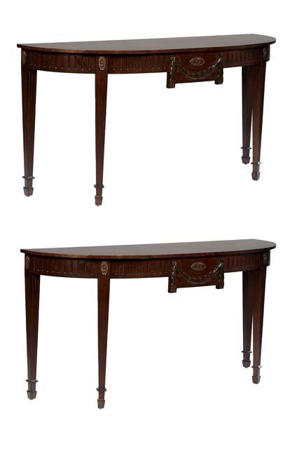 Pair of Large Carved Mahogany Sheraton Style Console Tables, 20th c., the demilune top over a reeded (1 of 3)