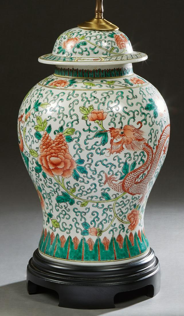 Chinese Famille Verte Covered Porcelain Ginger Jar, early 20th c., with colorful dragon, bird and: Chinese Famille Verte Covered Porcelain Ginger Jar, early 20th c., with colorful dragon, bird and floral decoration, now on a carved wooden base and wired as a lamp, H.- 20 in., Dia.- 11 in.