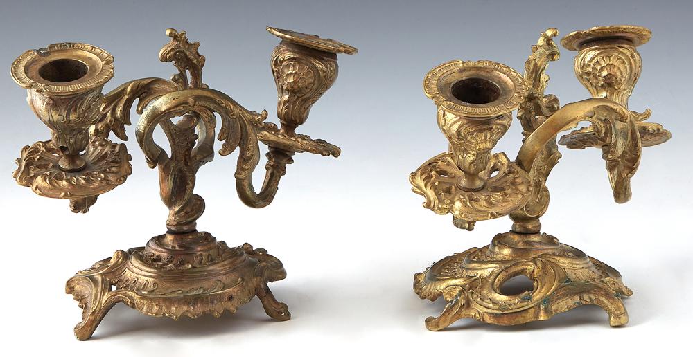 Pair of Diminutive Bronze Louis XV Style Two Light Candelabra, late 19th c., each with two swirled: Pair of Diminutive Bronze Louis XV Style Two Light Candelabra, late 19th c., each with two swirled arms with pierced bobeches and relief candle cups, on a pierced circular base on four C-scroll feet, 