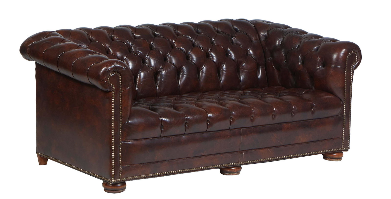 Brown Faux Leather Chesterfield Sofa, 20th c., with a tufted rolled back and arms, with iron tack de: Brown Faux Leather Chesterfield Sofa, 20th c., with a tufted rolled back and arms, with iron tack decoration, on turned bun feet, H.- 28 in., W.- 66 in., D.- 33 in.