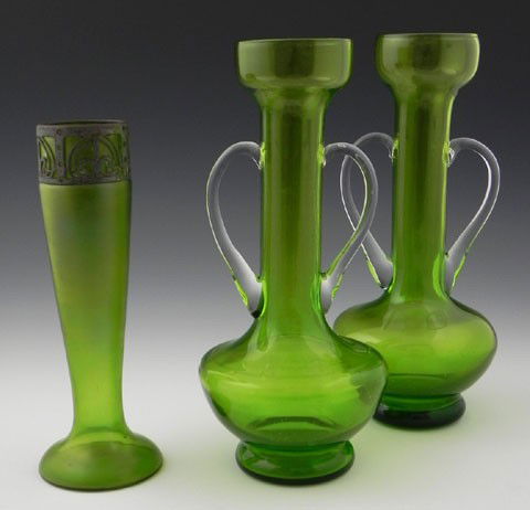Group of Three Green Blown Glass Vases, early 20th: Group of Three Green Blown Glass Vases, early 20th c., consisting of a pair of amphora form, with applied clear glass handles, together with an iridescent tapered example with a pierced metal collar w