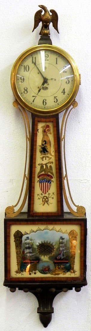 Carved and Banded Mahogany Banjo Electric Wall Clo: Carved and Banded Mahogany Banjo Electric Wall Clock, 20th c., by Sangamo, Model 7042, Type A, with a brass eagle surmount, the center with an eglomise painting of an eagle and a shield, the lower sec