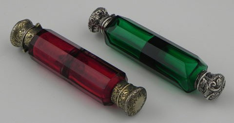 Two Victorian Double Sided Purse Perfume Bottles, : Two Victorian Double Sided Purse Perfume Bottles, 19th c., one of ruby glass, the other emerald glass, with silver plated stoppers.