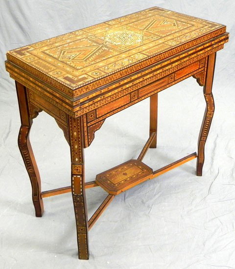 Unusual Moroccan Marquetry Inlaid Mahogany Games T: Unusual Moroccan Marquetry Inlaid Mahogany Games Table, late 19th c., with elaborate colored wood and mother-of-pearl inlay. The interior with a reversible fold out inlaid games board, the other side 
