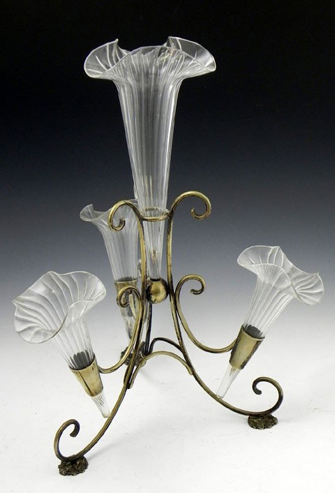 English Silver Plate Epergne, early 20th c., with : English Silver Plate Epergne, early 20th c., with four clear blown ribbed glass floriform trumpet vases on scrolling supports to tripodal leaf form feet, H.- 16 1/2 in., Dia.- 13 3/4 in.