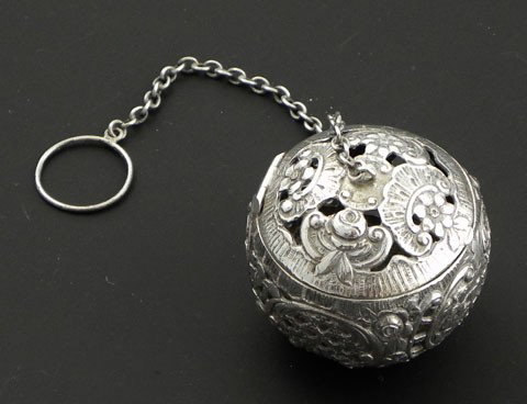 Continental .800 Silver Tea Ball, late 19th c., pe: Continental .800 Silver Tea Ball, late 19th c., perhaps Dutch, with pierced relief decorations and a cartouche of a farm couple and a cow, with a hanging chain and ring, H.- 2 in., Dia.- 2 in., wt.- 2