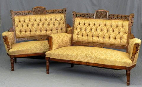 Pair of American Carved Walnut Settees, late 19th: Pair of American Carved Walnut Settees, late 19th c., with floral carved arched crests flanked by incised and pierce carved crest rails, over tufted backs to floral and incise carved arms, the whole o