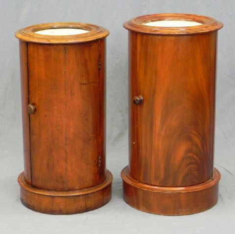 Near Pair of English Carved Mahogany Cylindrical C: Near Pair of English Carved Mahogany Cylindrical Columnar Pot Cupboards, 19th c., with inset white marble tops, on plinth bases, H.- 28 1/2 in., Dia.- 16 1/2 in., and H.- 27 3/4 in., Dia.- 15 in.