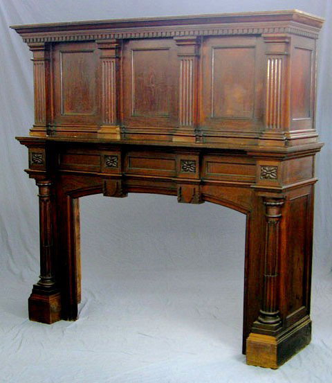 French Carved Oak Mantel, c. 1880, the over mantel: French Carved Oak Mantel, c. 1880, the over mantel with a dentillated cornice and a paneled back separated by reeded stiles, on a base with an arched opening flanked by carved reeded columns, H.- 77 1