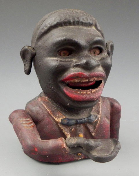 Cast Iron Jolly Negro Mechanical Bank, late 19th c: Cast Iron Jolly Negro Mechanical Bank, late 19th c., with moveable hand, eyes and ears, with remnants of original paint, H.- 6 1/4 in., W.- 5 in., D.- 6 in.