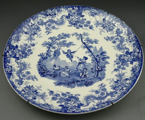 Minton's Circular Charger, c. 1900, in blue and w: Minton's Circular Charger, c. 1900, in blue and white, the floral decorated border around a central reserve of children playing in a garden, the bottom stamped and impressed "Mintons" and "33," H.- 1 