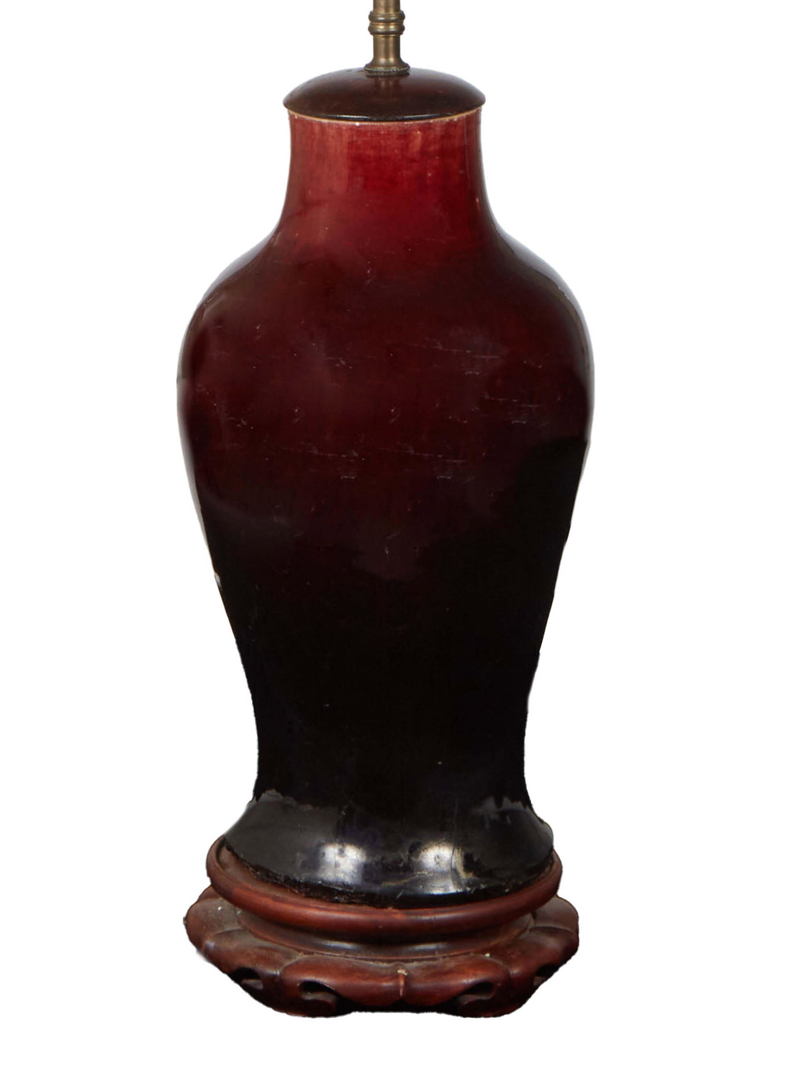 Oriental Oxblood Porcelain Baluster Vase, 19th c., now with a wooden cap and circular base, wired as (1 of 2)