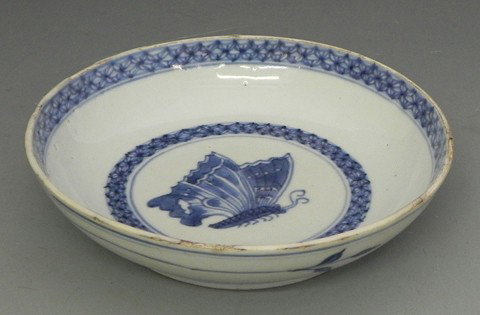 Chinese Porcelain Plate, 18th c., the rim with blu: Chinese Porcelain Plate, 18th c., the rim with blue geometric decoration, the exterior with leaf and branch decoration, the interior with a central butterfly, signed on the bottom with a dragon's head