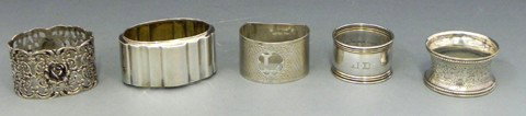 Group of Five Silver Napkin Rings- a German pierce: Group of Five Silver Napkin Rings- a German pierced sterling example with relief putti; a German .800 silver ribbed example; an English sterling pierced demi-lune example, Birmingham, 1932; a sterling