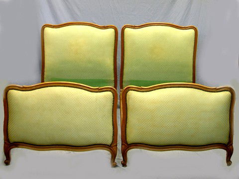 Pair of Louis XV Style Carved Walnut Beds, early 2: Pair of Louis XV Style Carved Walnut Beds, early 20th c., with upholstered arched headboards and footboards, with brass tack upholstery, and edge leaf carving, H.- 46 in., Int. W.- 36 1/2 in., Int. D.