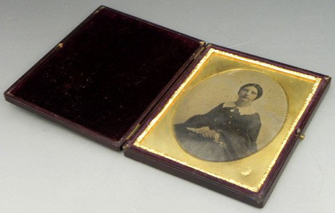 Matthew Brady Half Plate Ambrotype, mid 19th c., o: Matthew Brady Half Plate Ambrotype, mid 19th c., of a woman in a lace collar, the gilt liner marked "Brady, N. Y.," in a leather case, Image- H.- 4 1/2 in., W.- 3 1/2 in.