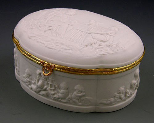 Limoges Biscuit Porcelain Shaped Oval Sweetmeats Bo: Limoges Biscuit Porcelain Shaped Oval Sweetmeats Box, early 20th c., the lid with relief decoration of classical women and putti in a garden, the sides of the box with relief decoration of frolicking 