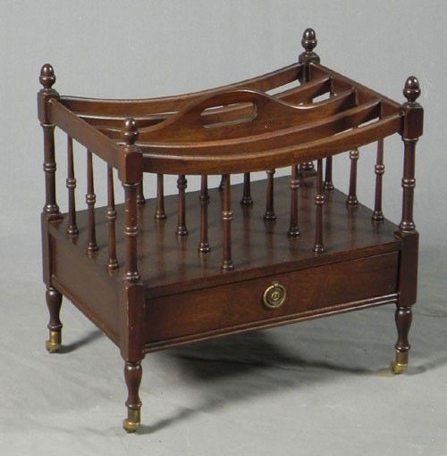 Victorian Style Carved Mahogany Canterbury, 20th c.: Victorian Style Carved Mahogany Canterbury, 20th c., with a central handle and divided top, over a lower drawer, on turned legs to brass cap casters, H.- 19 1/2 in., W.- 19 in., D.- 13 in.