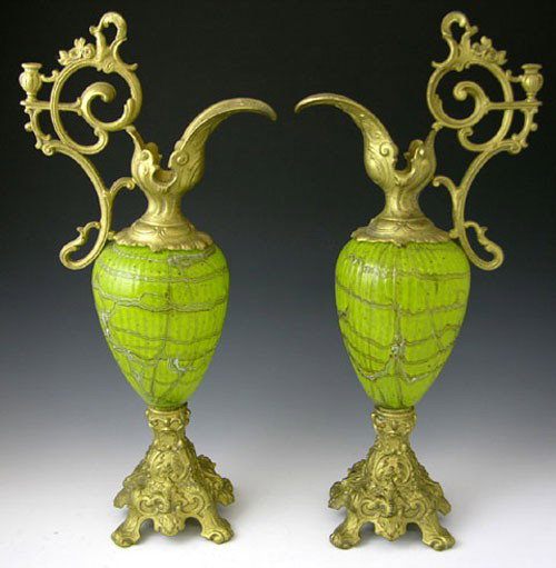 Pair of Unusual Art Glass and Spelter Ewers, 19th c: Pair of Unusual Art Glass and Spelter Ewers, 19th c., the ribbed tapered glass bodies with multi-colored swirled line decoration, with gilt spelter pouring lips and bases, H.- 18 1/2 in., W.- 8 1/2 in