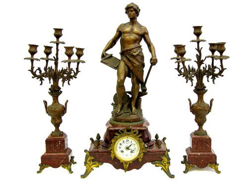 Patinated Spelter and Red Marble Three Piece Clock: Patinated Spelter and Red Marble Three Piece Clock Set, c. 1880, the clock with a large male figure representing Industry, with a pair of matching five light urn form candelabra, Clock- H.- 27 3/4 in.