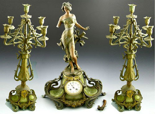 Three Piece Art Nouveau Patinated Spelter and Gre: Three Piece Art Nouveau Patinated Spelter and Green Onyx Clock Set, c. 1910, the clock with a female statue, with a pair of conforming five light candelabra, the arm of the female off but present, Clo