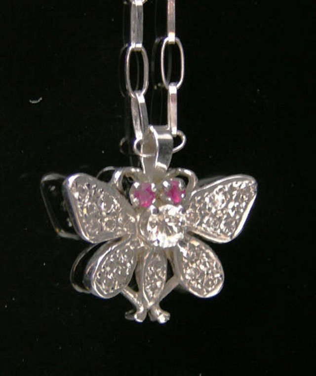 14K White Gold Butterfly Pendant, the butterfly wi: 14K White Gold Butterfly Pendant, the butterfly with ruby eyes, a single round diamond mounted back, and small diamond mounted wings, on a 14K white gold large link chain, L.- 17 1/2 in.