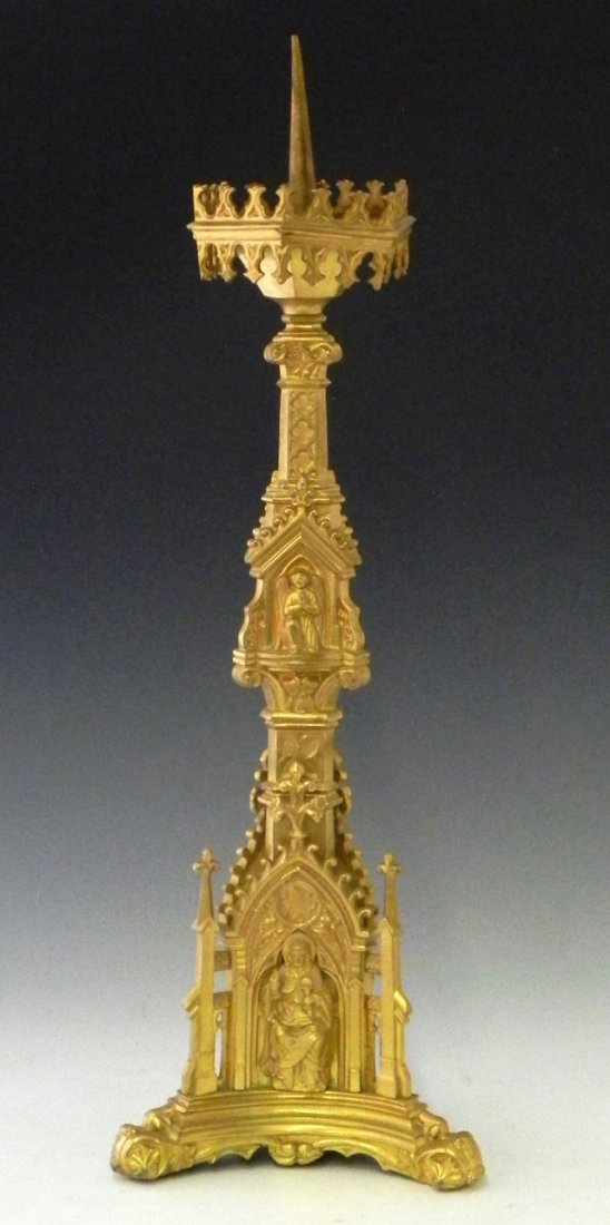 Gilt Bronze Pricket Altar Candlestick, 19th c., th: Gilt Bronze Pricket Altar Candlestick, 19th c., the support with a tripodal support, the center band with relief angels' heads, to a tripodal base with relief figures of Jesus, Mary and St. Peter, H.-
