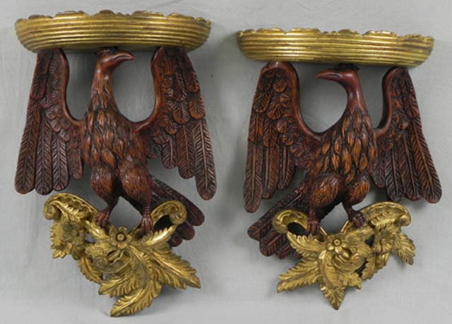 Pair of Carved Mahogany Wall Brackets, 20th c., th: Pair of Carved Mahogany Wall Brackets, 20th c., the gilt shelves of demi-lune form, on eagle carved supports, H.- 17 in., W.- 11 3/4 in., D.- 5 3/4 in.