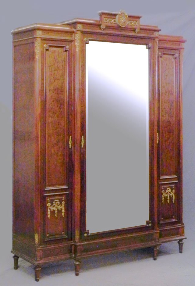 Three Piece Carved Mahogany Louis XVI Style Ormolu: Three Piece Carved Mahogany Louis XVI Style Ormolu Mounted Bedroom Suite, c. 1900, consisting of a single bed, oval marble top nightstand, and an armoire with a large wide beveled central mirror door,