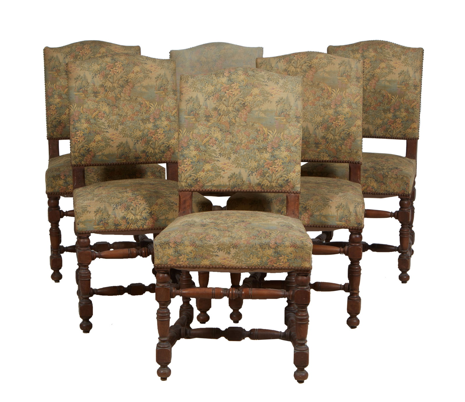 Set of Six French Louis XIII Style Carved Walnut Dining Chairs, early 20th c., H.- 38 1/4 in., W.-: Set of Six French Louis XIII Style Carved Walnut Dining Chairs, early 20th c., the canted arched cushioned back over a trapezoidal seat, on turned and block legs joined by like stretchers, in muted la