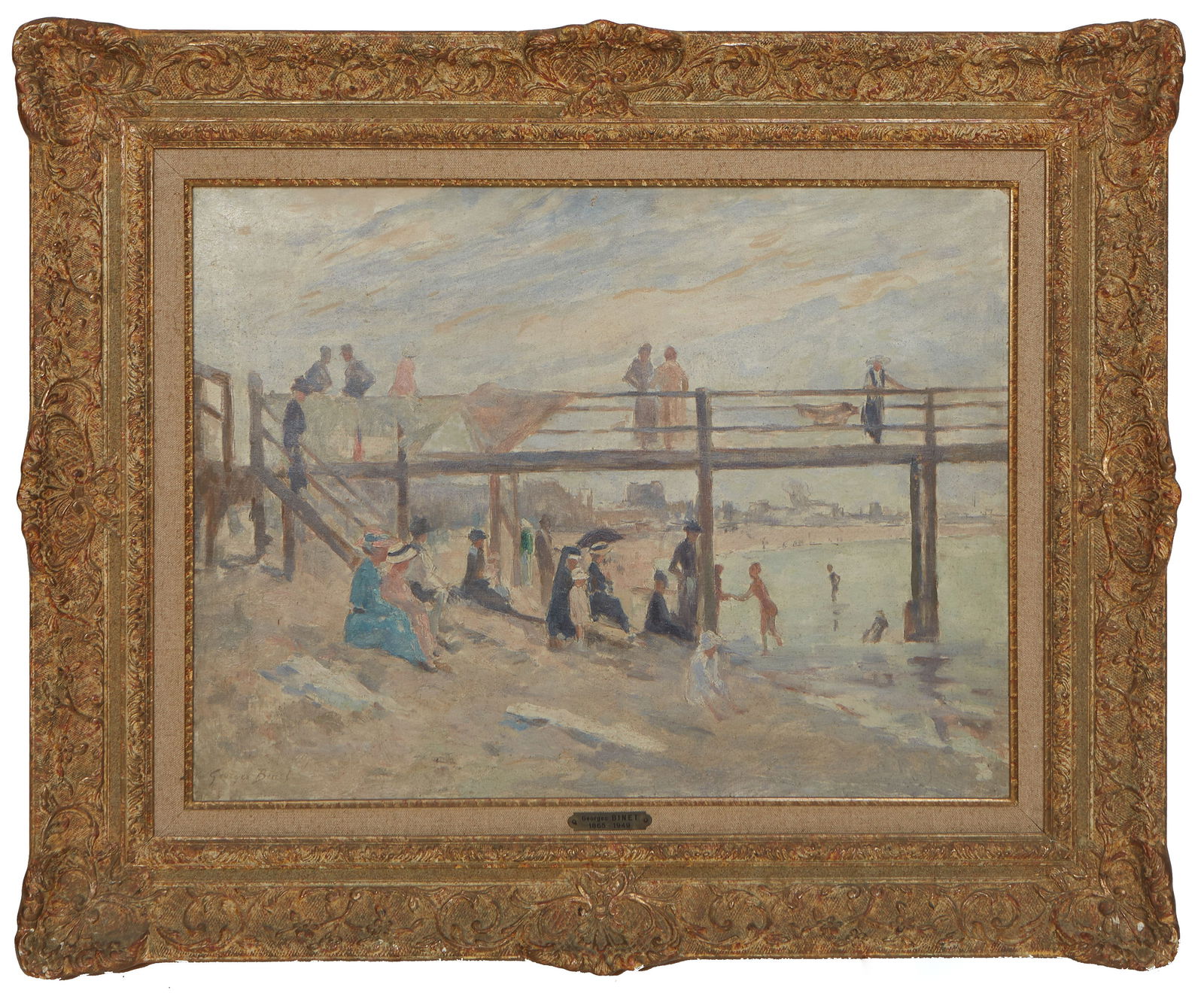George Jules Ernest Binet (French, 1865-1949), "Beach Scene by the Boardwalk," H.- 17 3/4 in., W.-: George Jules Ernest Binet (French, 1865-1949), "Beach Scene by the Boardwalk," oil on canvas, signed lower left, presented in a wood frame with a French framer's label en verso, H.- 17 3/4 in., W.- 23