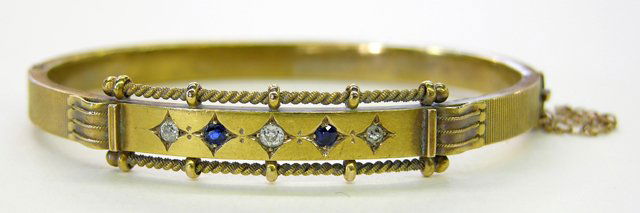 15K Yellow Gold Hinged Bangle Bracelet, c. 1900, m: 15K Yellow Gold Hinged Bangle Bracelet, c. 1900, mounted with three small round diamonds separated by 2 round blue sapphires, H.- 3/8 in., Int. W.- 2 3/8 in., Int. D.- 1 7/8 in.