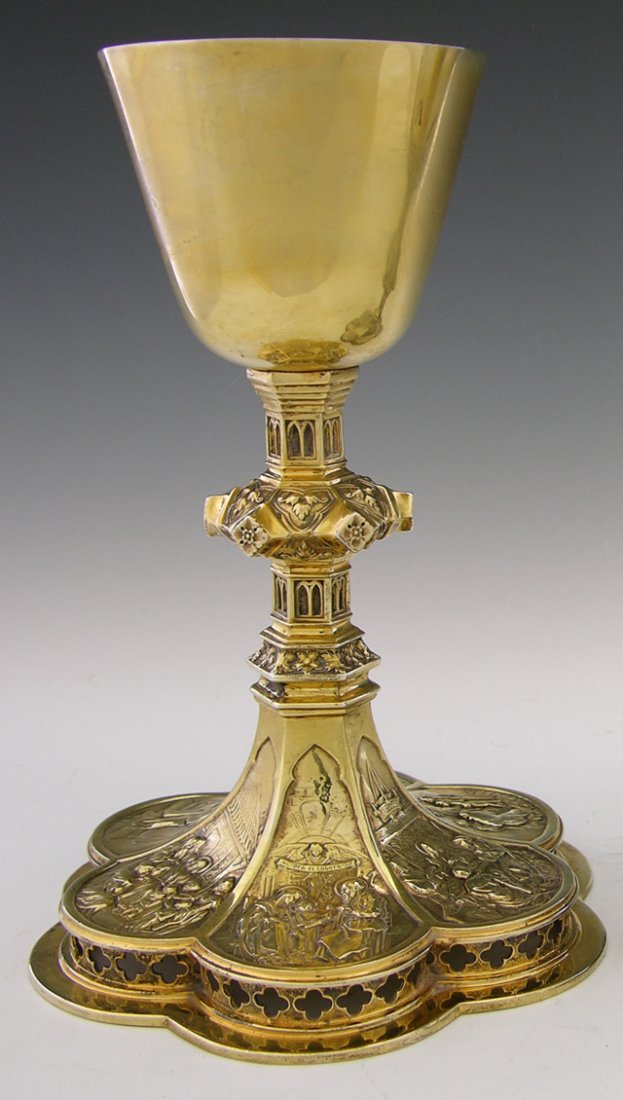 Gilt Washed Sterling Communion Chalice, 20th c., b: Gilt Washed Sterling Communion Chalice, 20th c., by P. J. Gill and Sons, with a relief Gothic support to a pierced lobed base with relief Repousse decorations of religious scenes, H.- 8 7/8 in., Dia.-